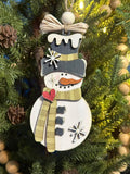 rustic snowman ornament with light green scarf and raffia bow