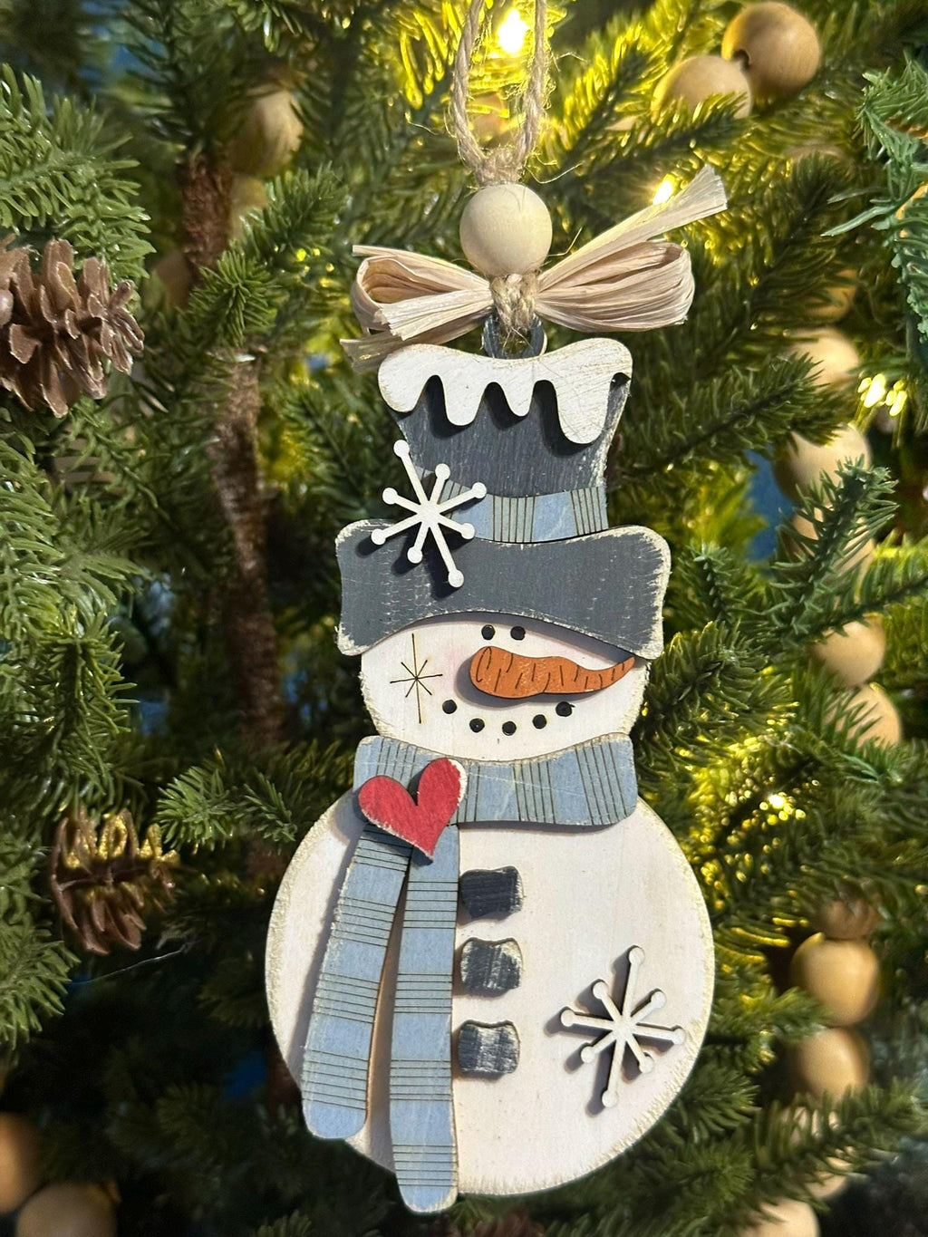 rustic snowman ornament with light blue scarf and raffia bow