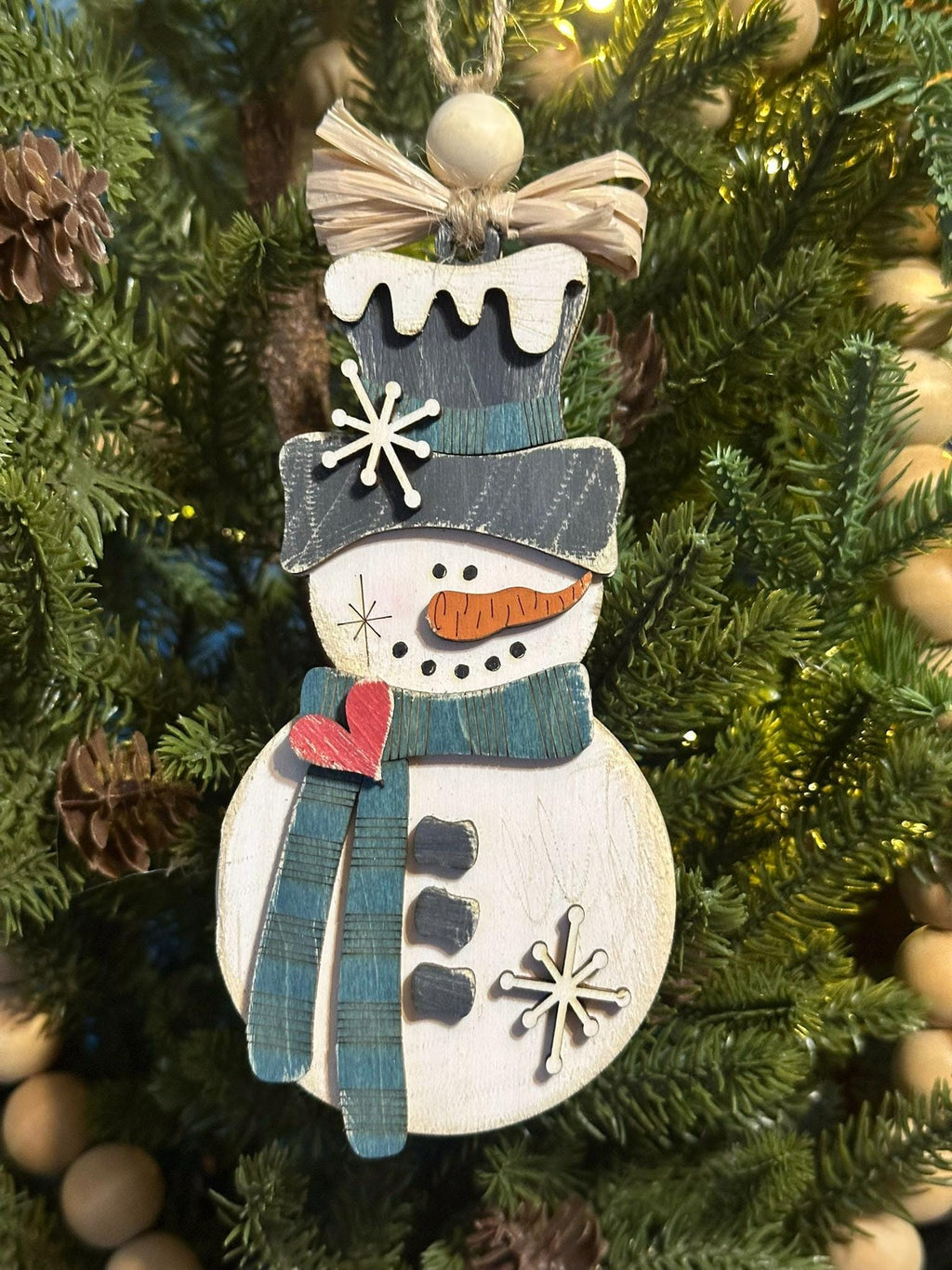 rustic snowman ornament with teal scarf and raffia bow