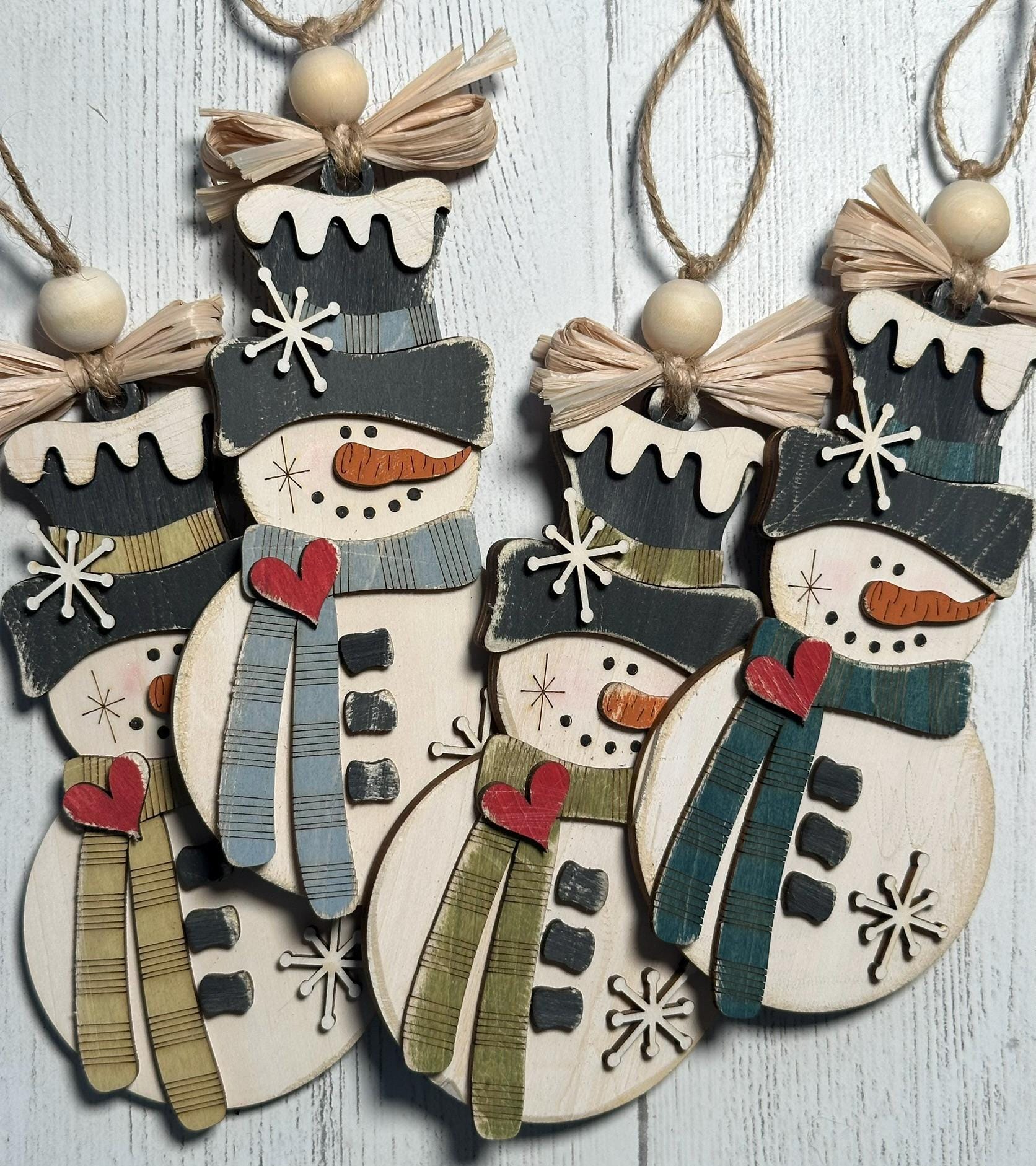 4 rustic snowman ornaments with assorted colors scarf and raffia bow