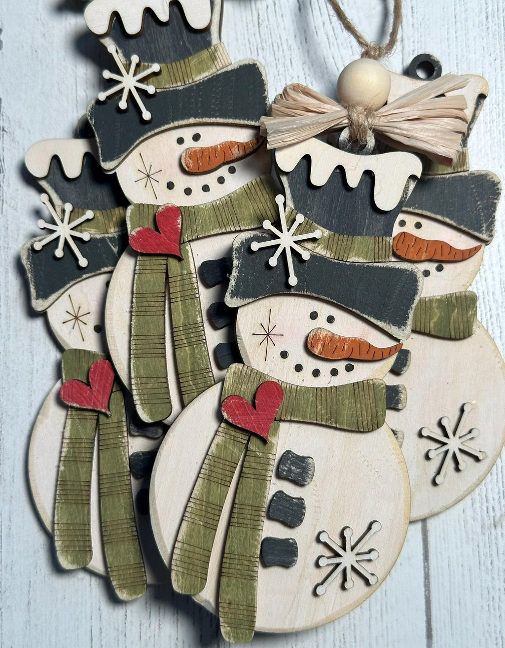 4 rustic snowman ornaments with green scarf and raffia bow
