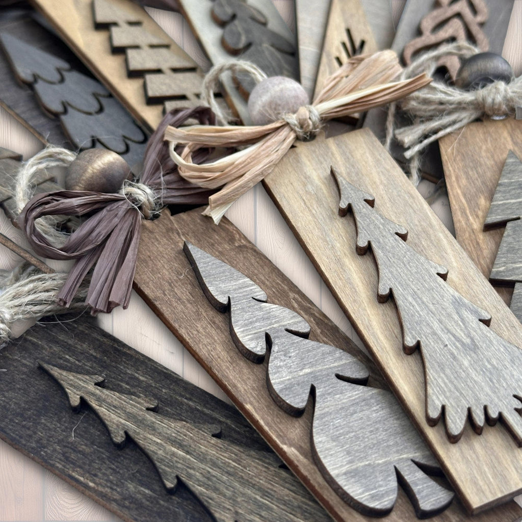 Close-up of rustic wooden tree ornaments showing natural texture and layered wood design.