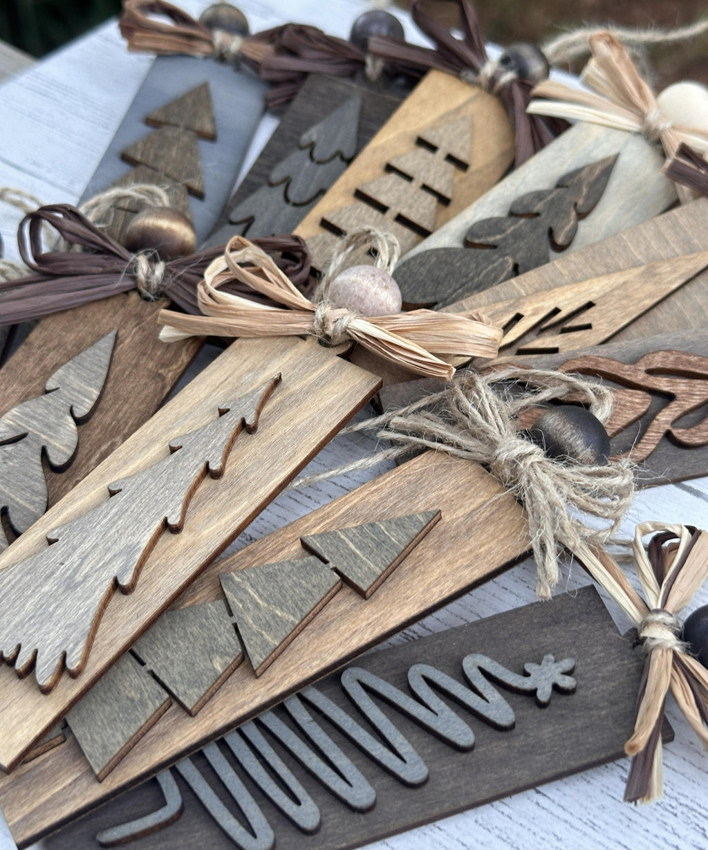 Rustic handmade wooden Christmas ornaments in neutral tones close-up detail shot.