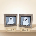 two wooden frames with ghost images inside them, labeled as "Ghost A" and "Ghost B".